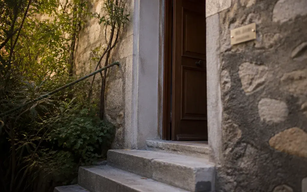 Entrée d’un cabinet libéral dans une maison de village à Auriol, plaque professionnelle sobre hors focus, porte en…